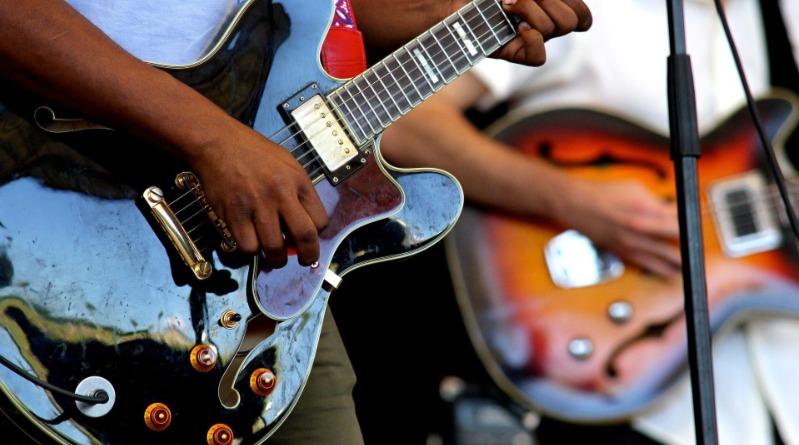 Person Playing Guitar