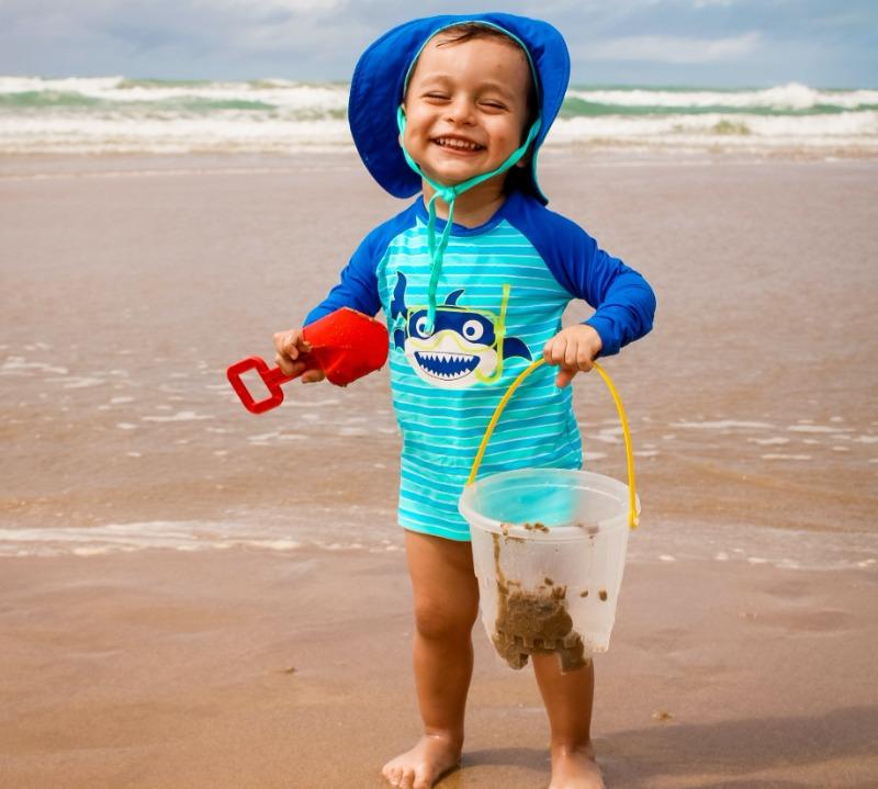 Kid Playing on Beach with Bucket