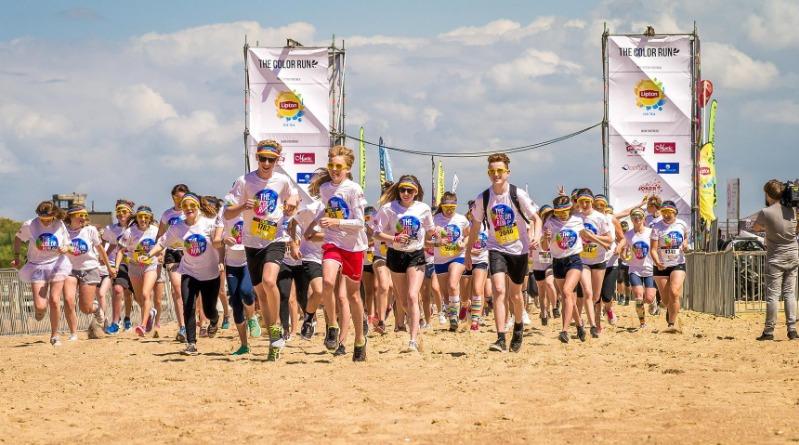 Group Of People Running On Beach