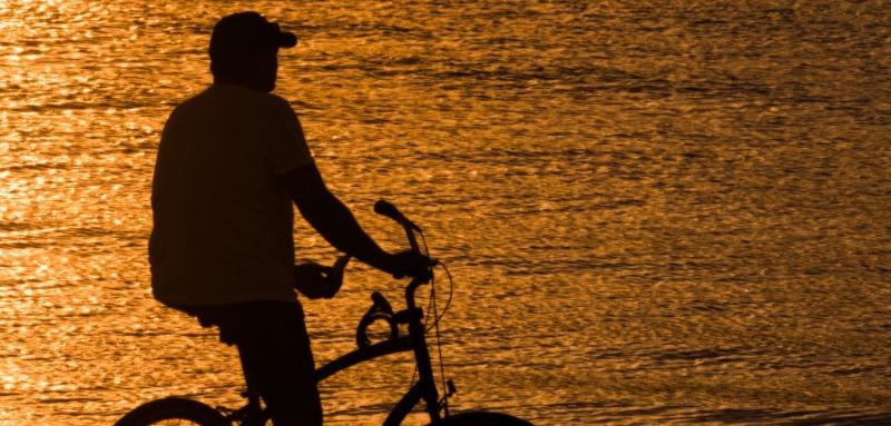 Man Riding Bike At Sunset