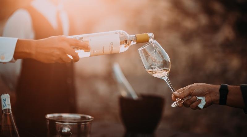 Person Pouring A Glass Of Wine